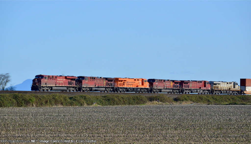 CP 8894/8535/8757/9716/8501/CN 2789 E/B approaching the Hwy 99 overpass and speed restricted to 10 mph, with a short unit stack train in tow...about 2900ft.